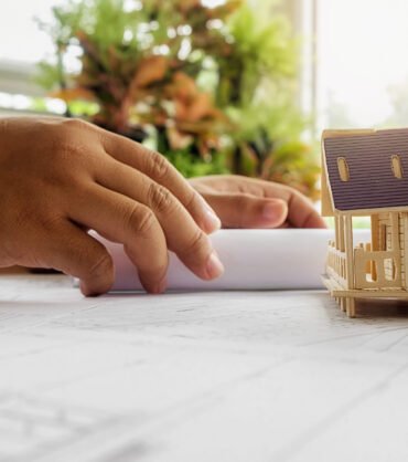 Hands of Engineer working on blueprint,Construction concept. Engineering tools.Vintage tone retro filter effect,soft focus(selective focus)