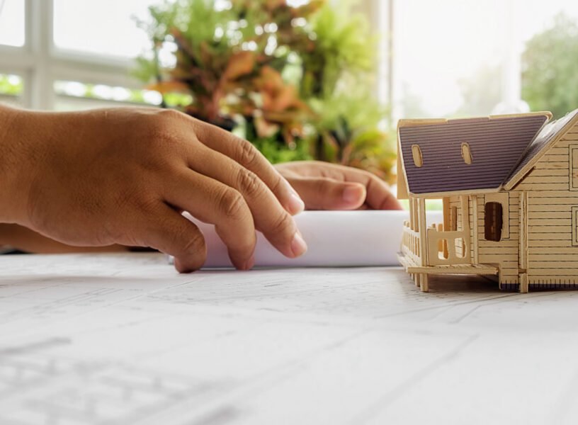 Hands of Engineer working on blueprint,Construction concept. Engineering tools.Vintage tone retro filter effect,soft focus(selective focus)